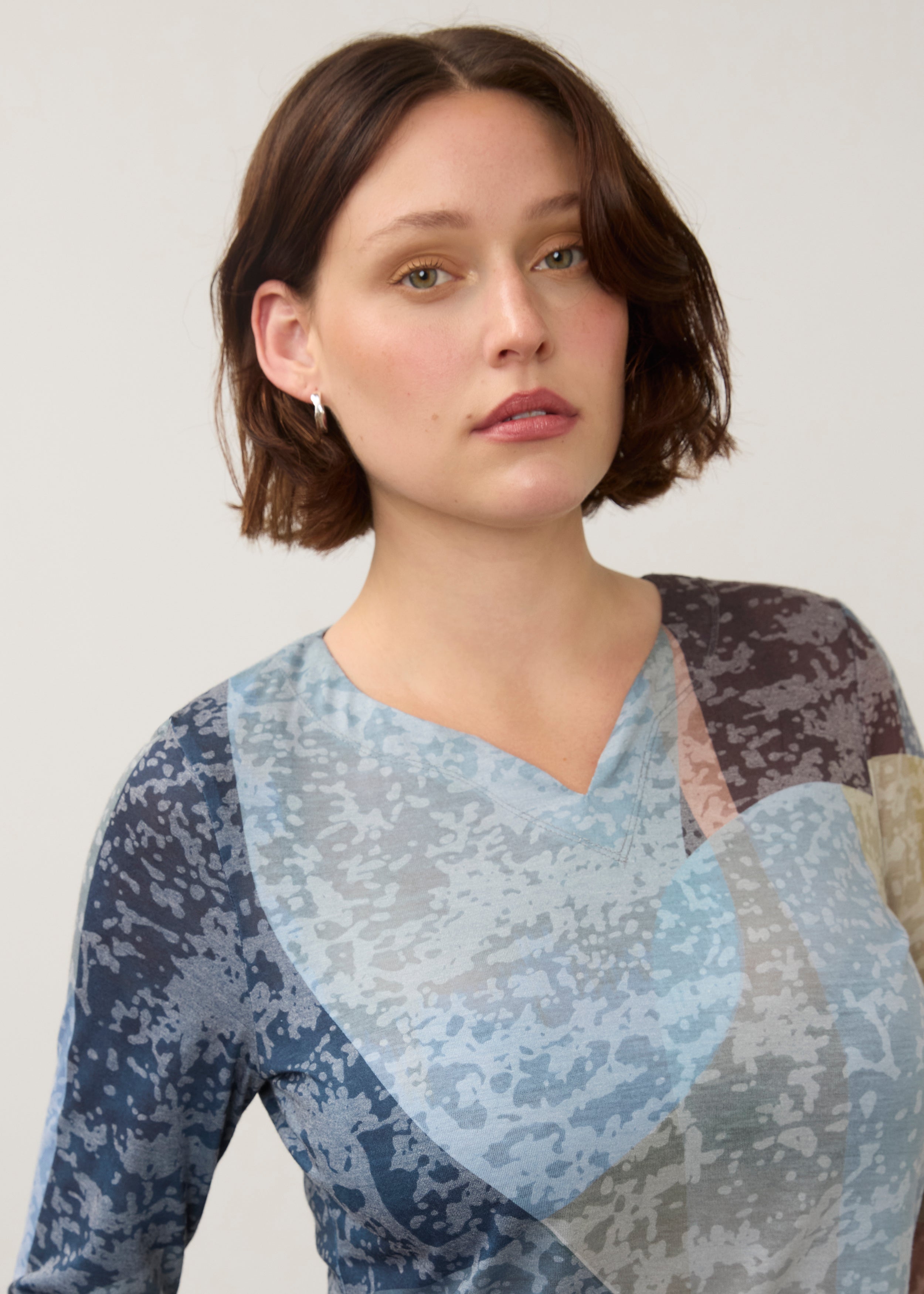 Close-up of notch neckline detail on 3/4 sleeve top in multi-color Warn pattern by French Dressing Jeans (FDJ)