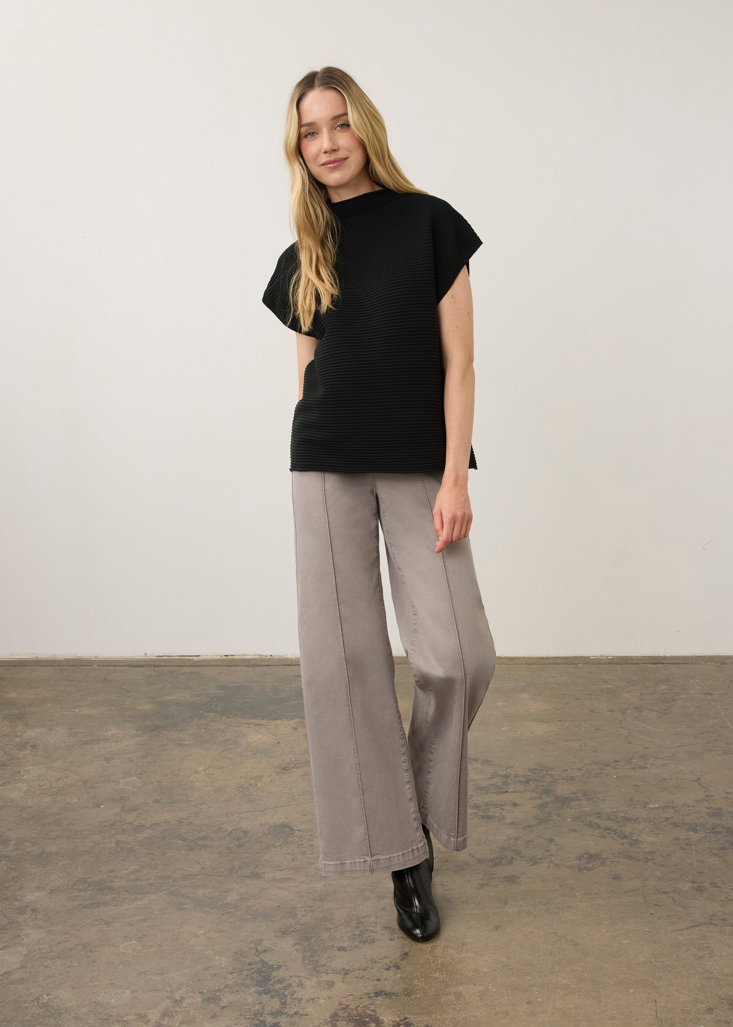 Model in black ribbed top paired with wide-leg pants, full outfit view by French Dressing Jeans (FDJ)