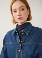 Close-up of oversized medium blue utility jacket with brass buttons by French Dressing Jeans (FDJ) par French Dressing Jeans (FDJ)