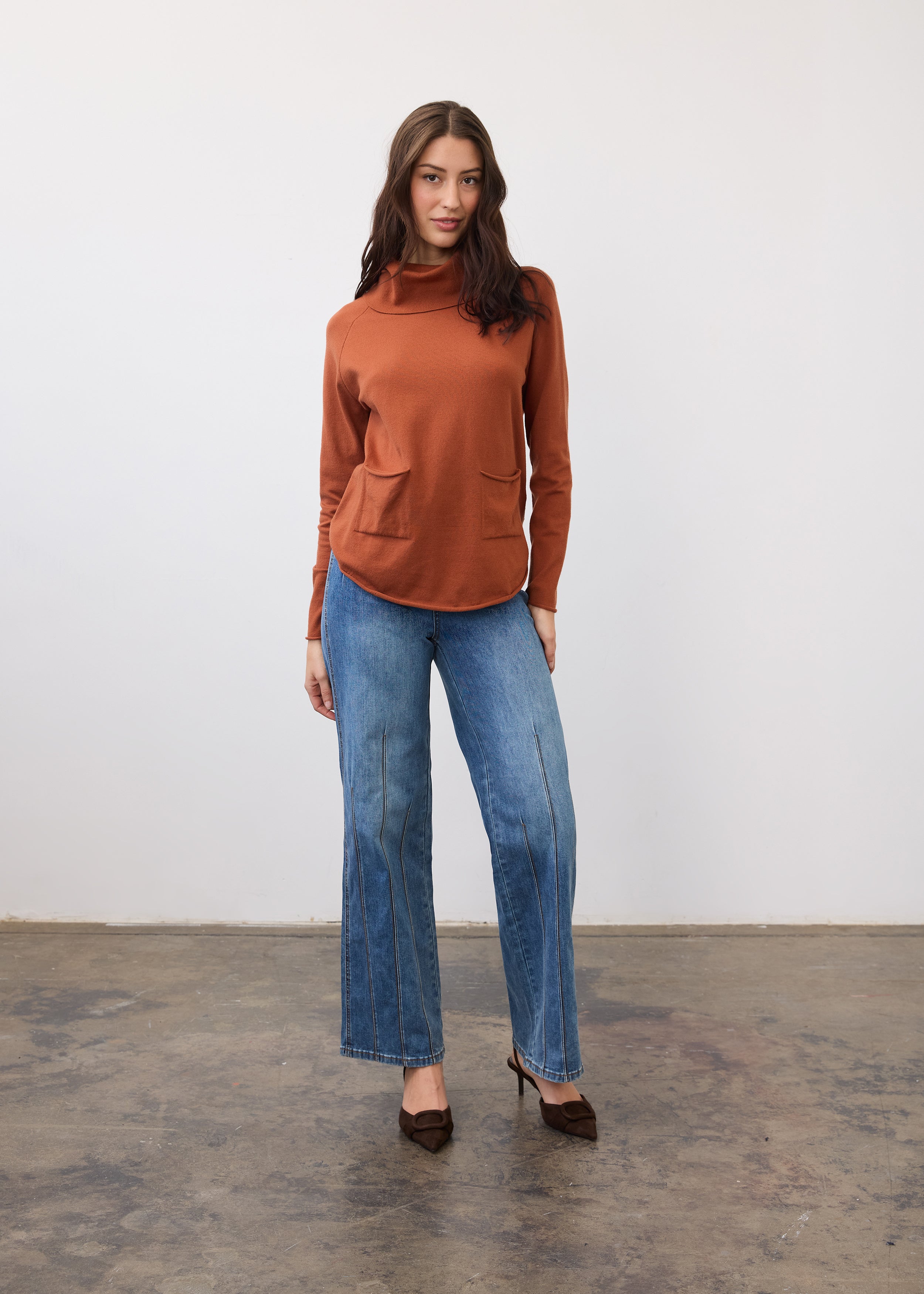 Full-length view of rust sweater styled with light blue jeans by French Dressing Jeans (FDJ)