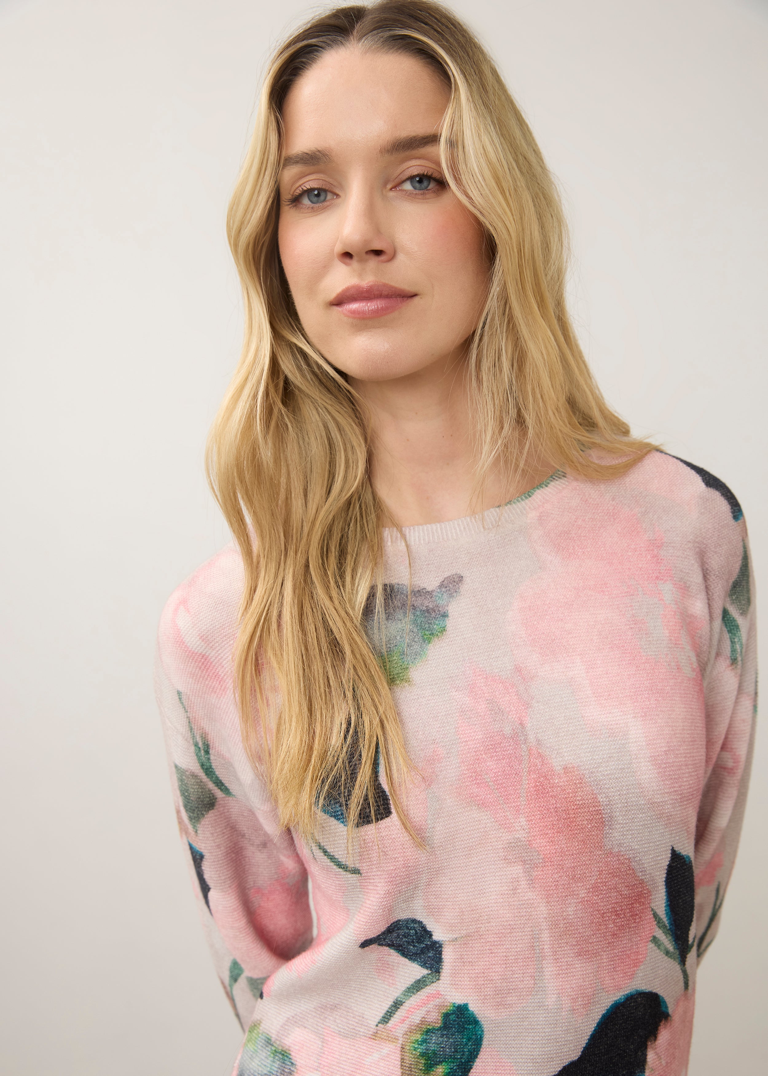 Close-up of floral print on pink sweater with crew neck detail by French Dressing Jeans (FDJ)