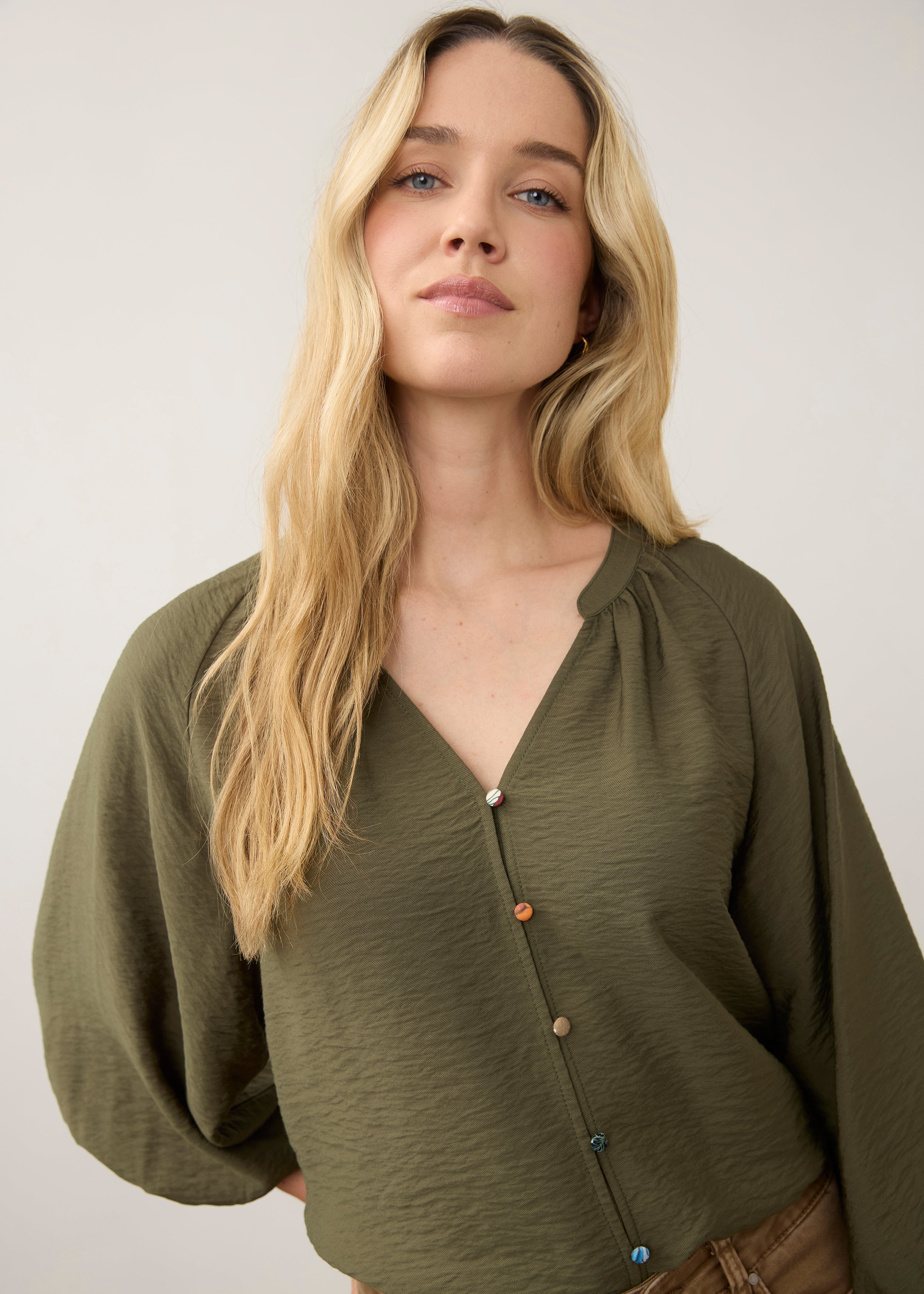 Close-up of olive blouse showing colorful buttons by French Dressing Jeans (FDJ)