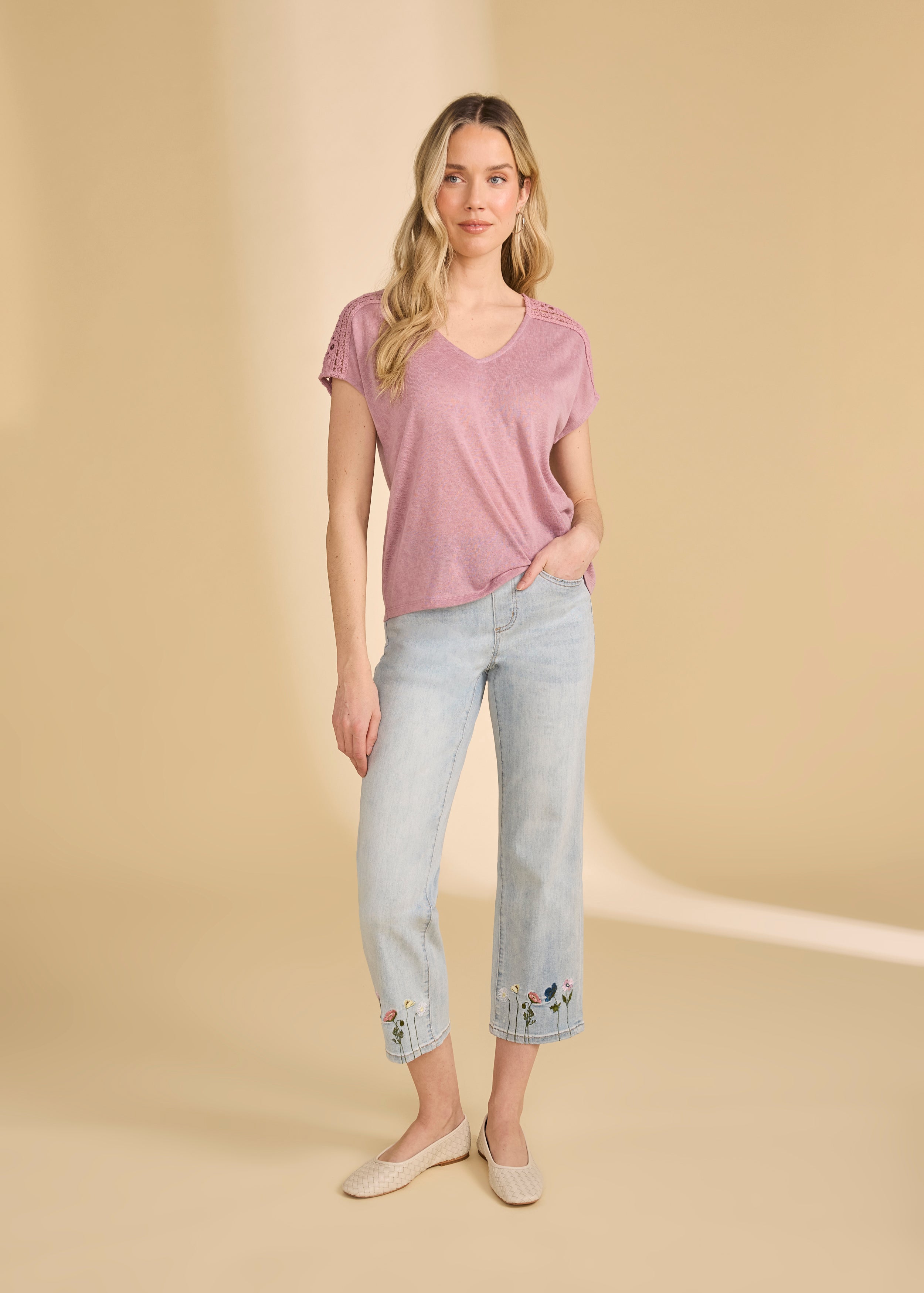 Model wearing light medium pull-on wide ankle denim with floral embroidery and pink top by French Dressing Jeans (FDJ)