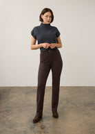 Full view of brown slim-fit pants paired with a dark top and loafers by French Dressing Jeans (FDJ) par French Dressing Jeans (FDJ)