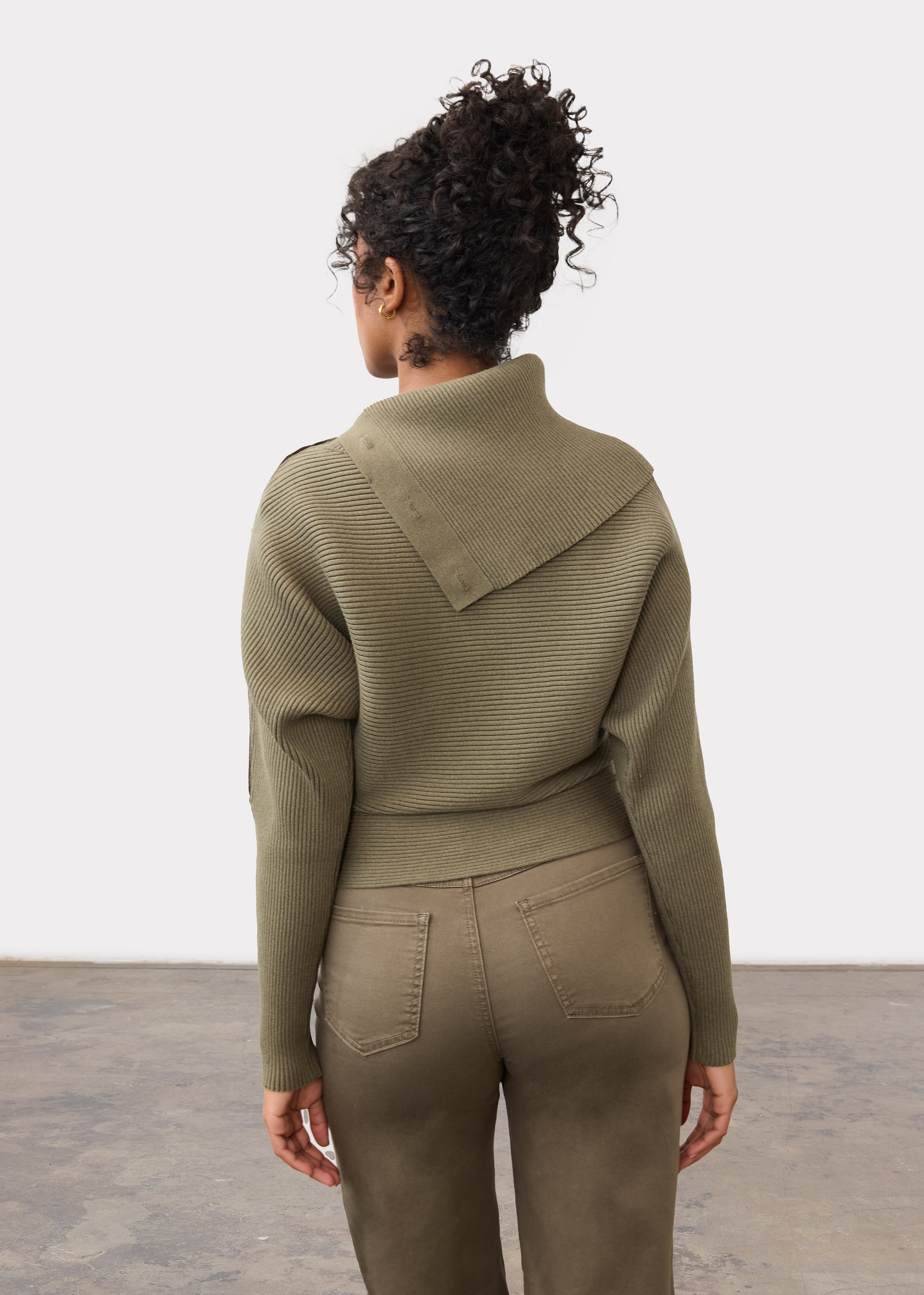 Back view of olive sweater highlighting ribbed design and button embellishments by French Dressing Jeans (FDJ)
