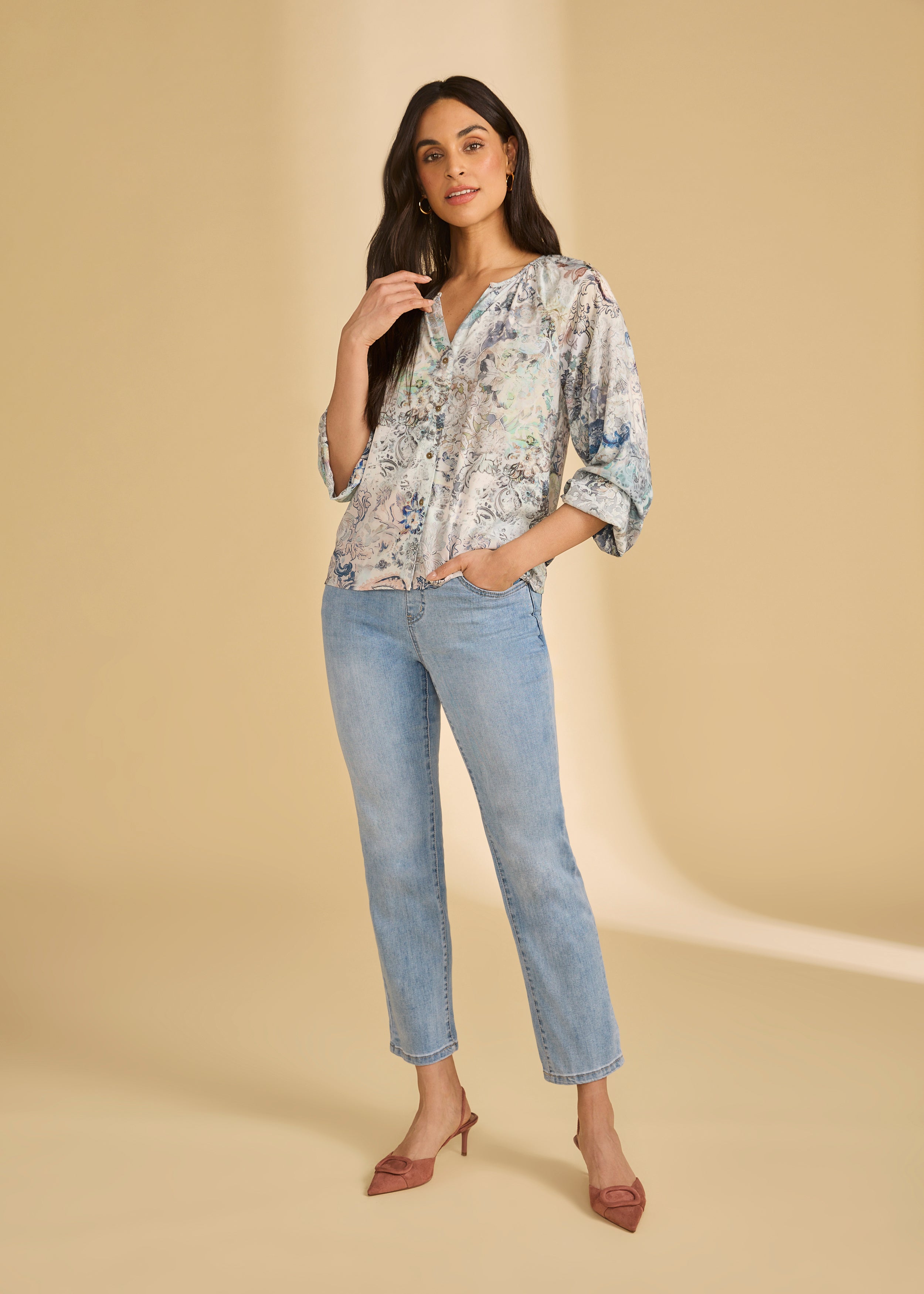 Model in light medium pull-on ankle jeans paired with a patterned blouse by French Dressing Jeans (FDJ)