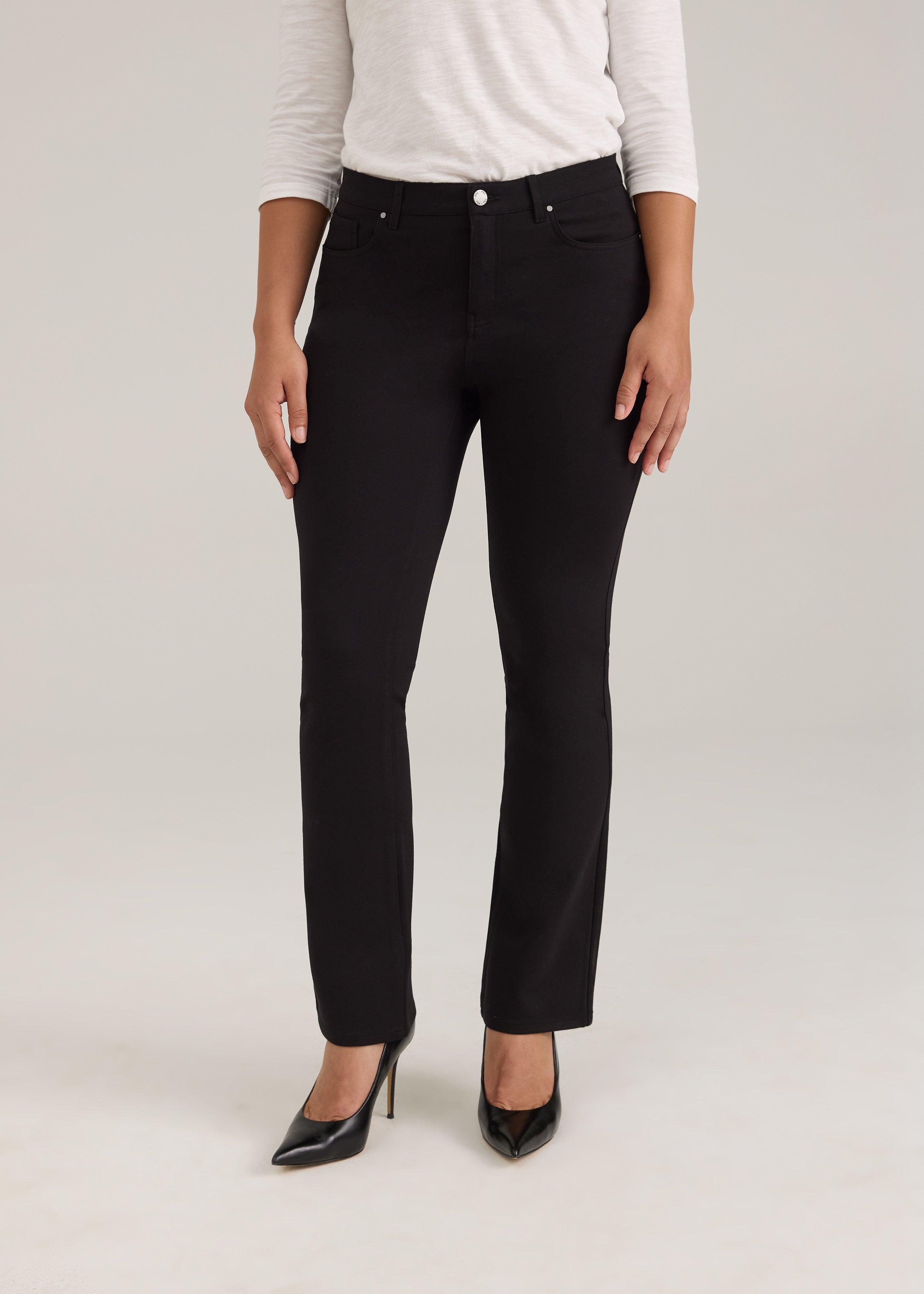 Front view of black pants with silver button and sleek design by French Dressing Jeans (FDJ)