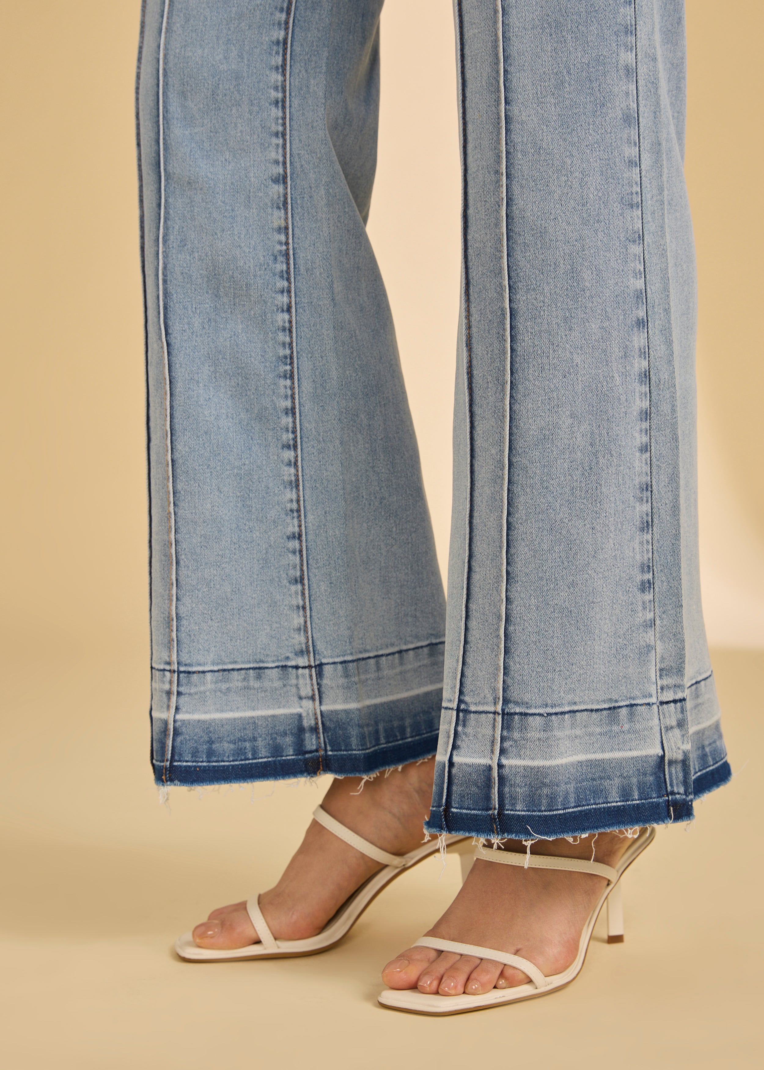 Close-up of light metallic lime trousers showing hem and seam detail by French Dressing Jeans (FDJ)