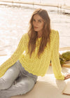 Outdoor shot of yellow lace sweater worn by a model by French Dressing Jeans (FDJ)