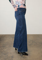 Side view of dark wash jeans highlighting straight leg fit with floral top by French Dressing Jeans (FDJ) par French Dressing Jeans (FDJ)