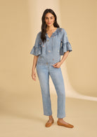 Full view of denim top with floral embroidery and straight-leg jeans by French Dressing Jeans (FDJ)