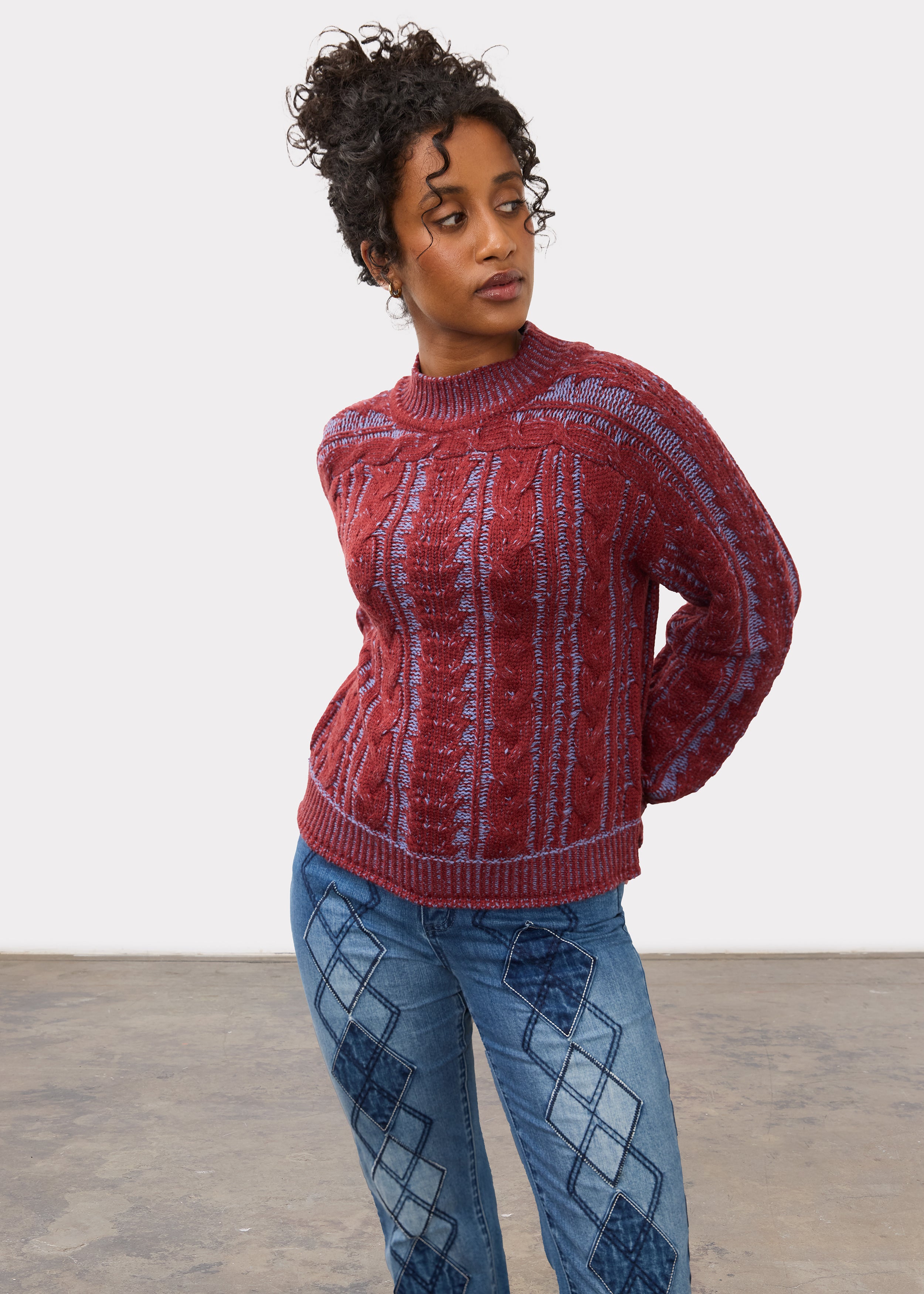 Side profile of maroon cabled sweater showing shoulder and sleeve design by French Dressing Jeans (FDJ)