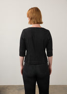Back view of black button-up top with elbow-length sleeves and seam detailing by French Dressing Jeans (FDJ)
