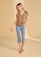 Full view of brown V-neck top paired with flower-patterned jeans by French Dressing Jeans (FDJ)