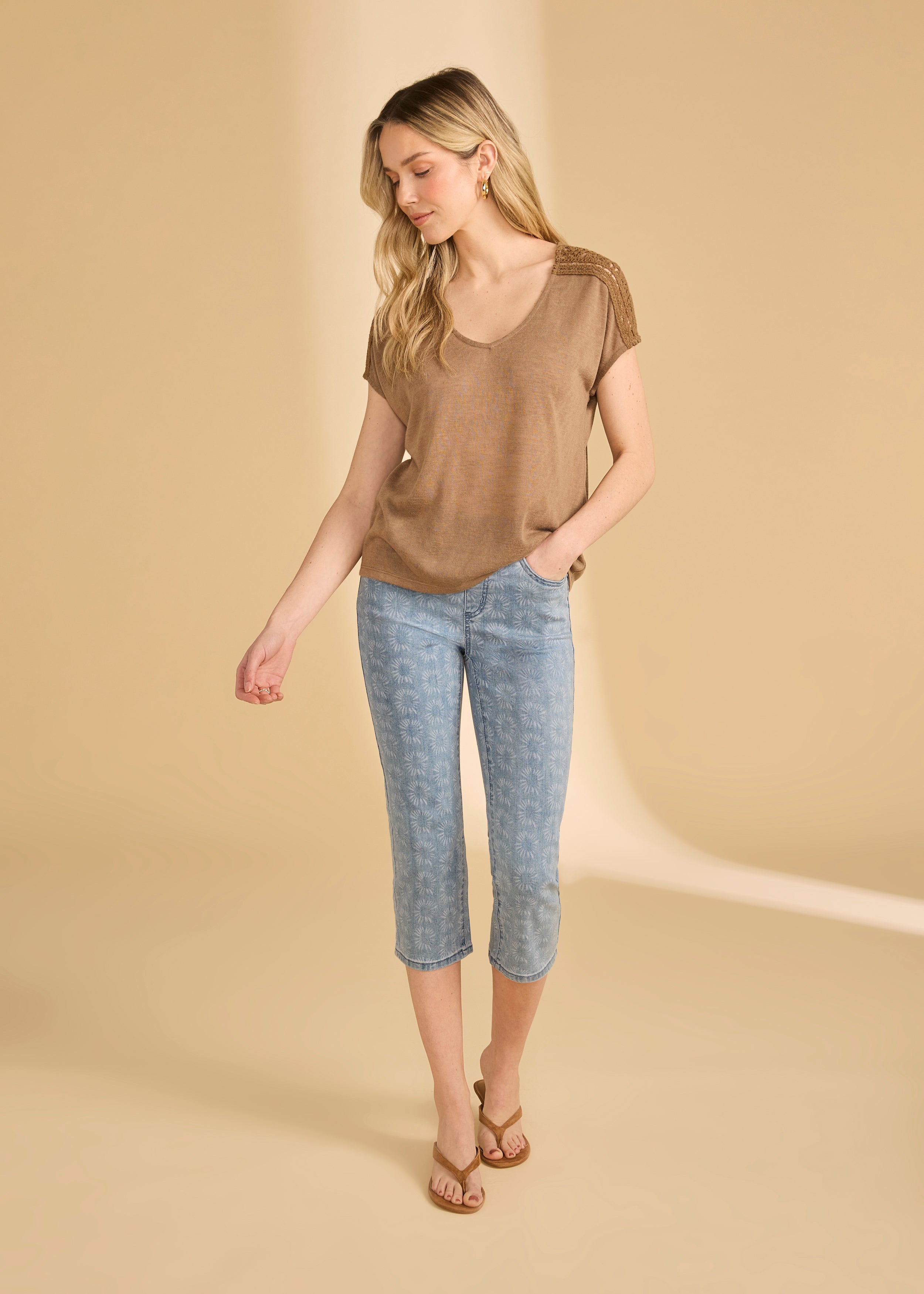 Full view of brown V-neck top paired with flower-patterned jeans by French Dressing Jeans (FDJ)