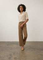 Model in striped beige and white shirt and khaki pants, full body view by French Dressing Jeans (FDJ)