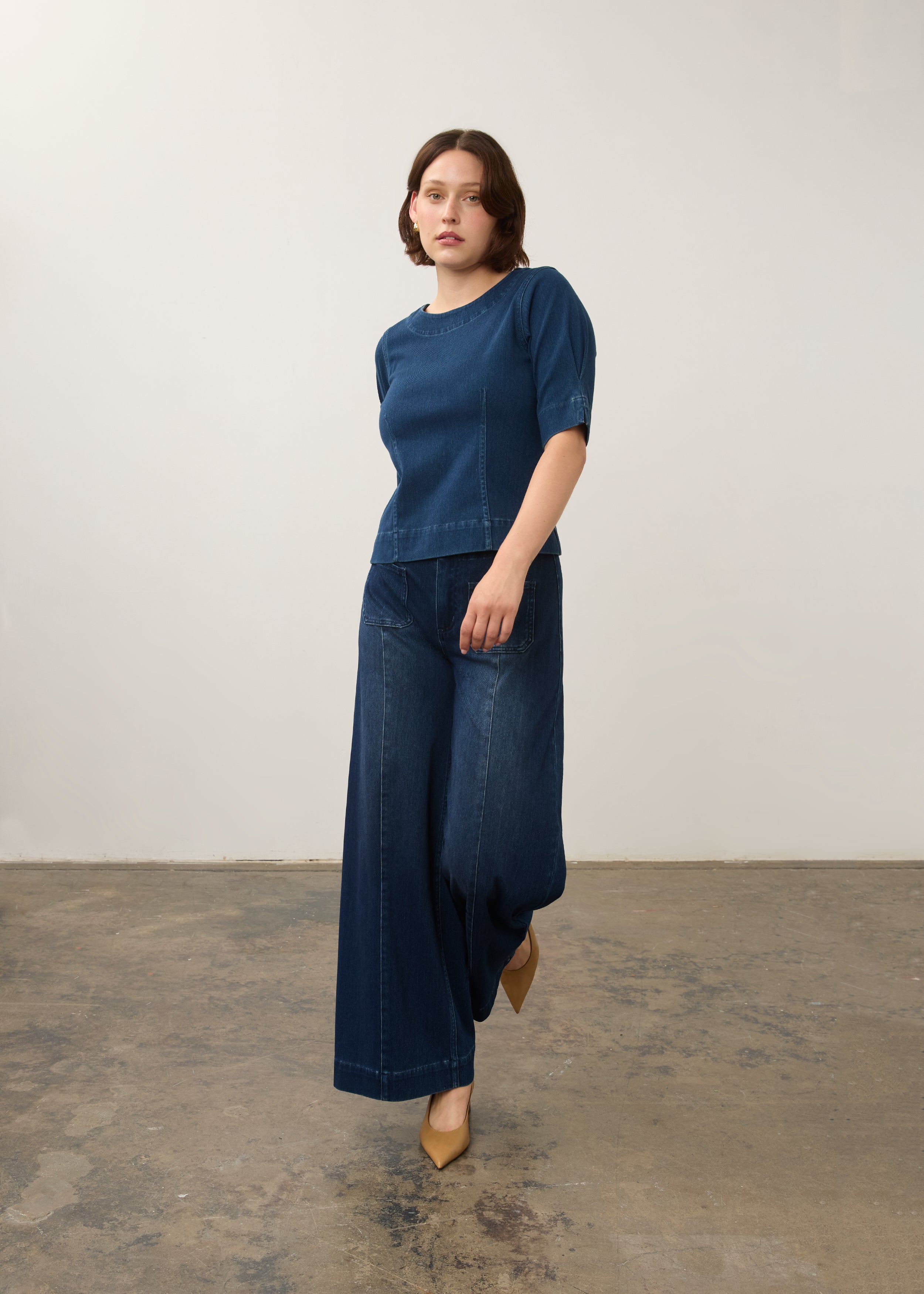 Full outfit view of dark rinse fitted top paired with matching wide-leg jeans by French Dressing Jeans (FDJ)