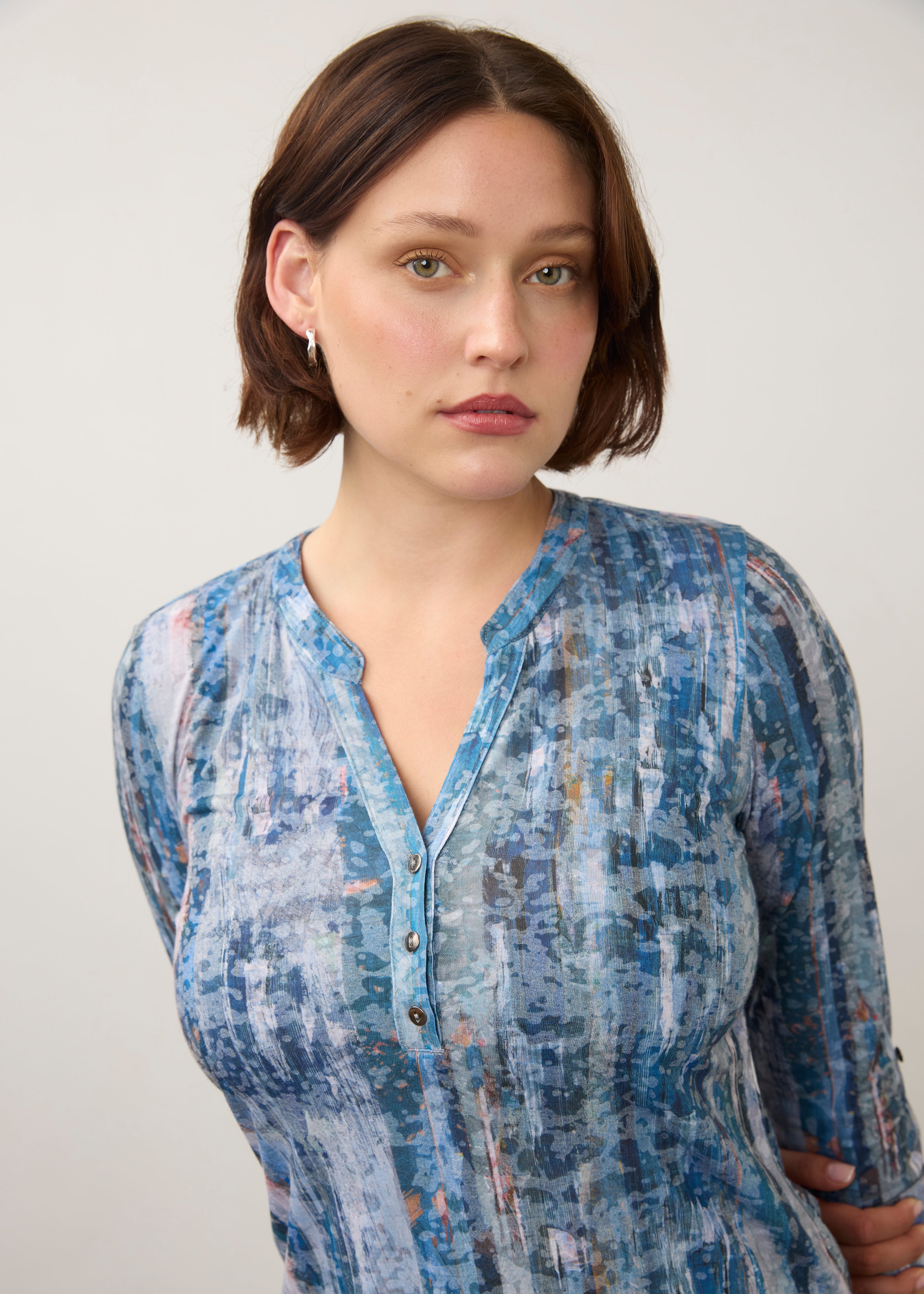 Close-up of button and neckline detail on blue patterned 3/4 sleeve top by French Dressing Jeans (FDJ)
