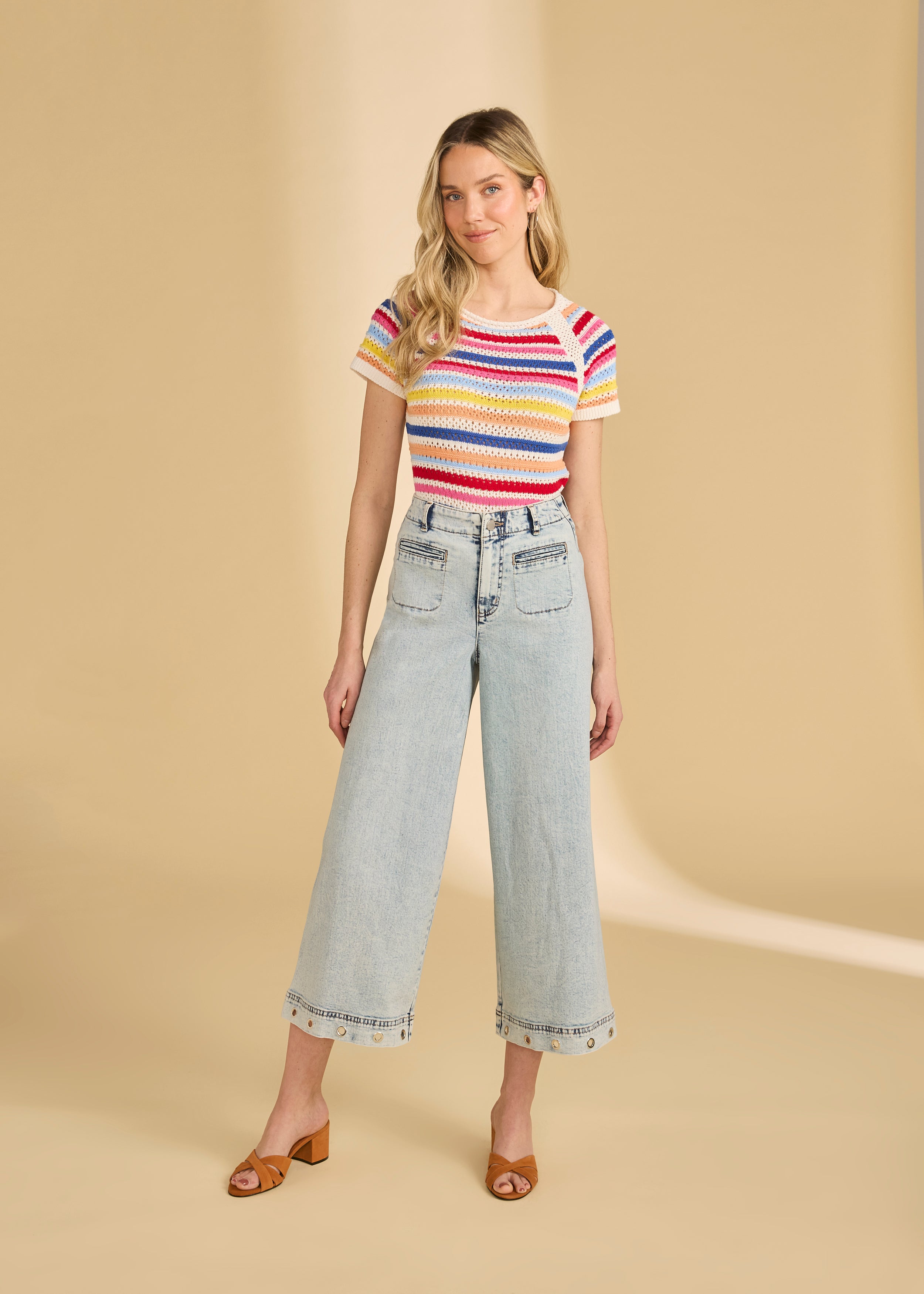 Full body view of multi-color stripe sweater styled with light denim jeans by French Dressing Jeans (FDJ)