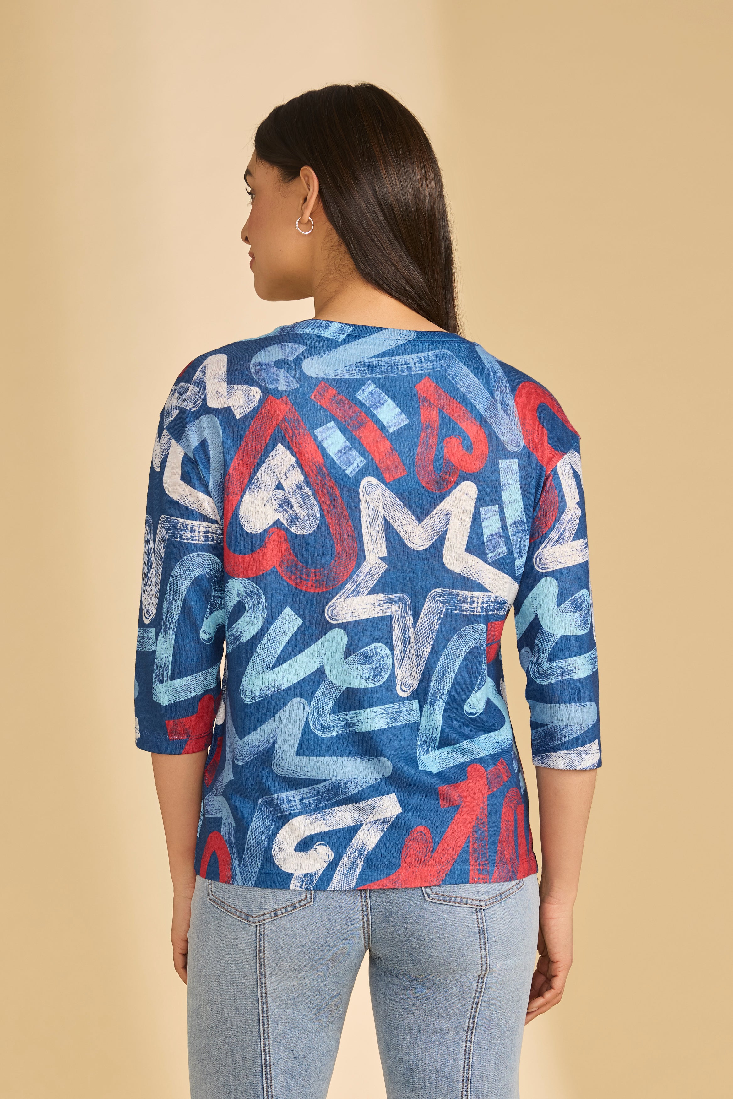 Back view of blue graphic top showcasing star and heart patterns by French Dressing Jeans (FDJ)