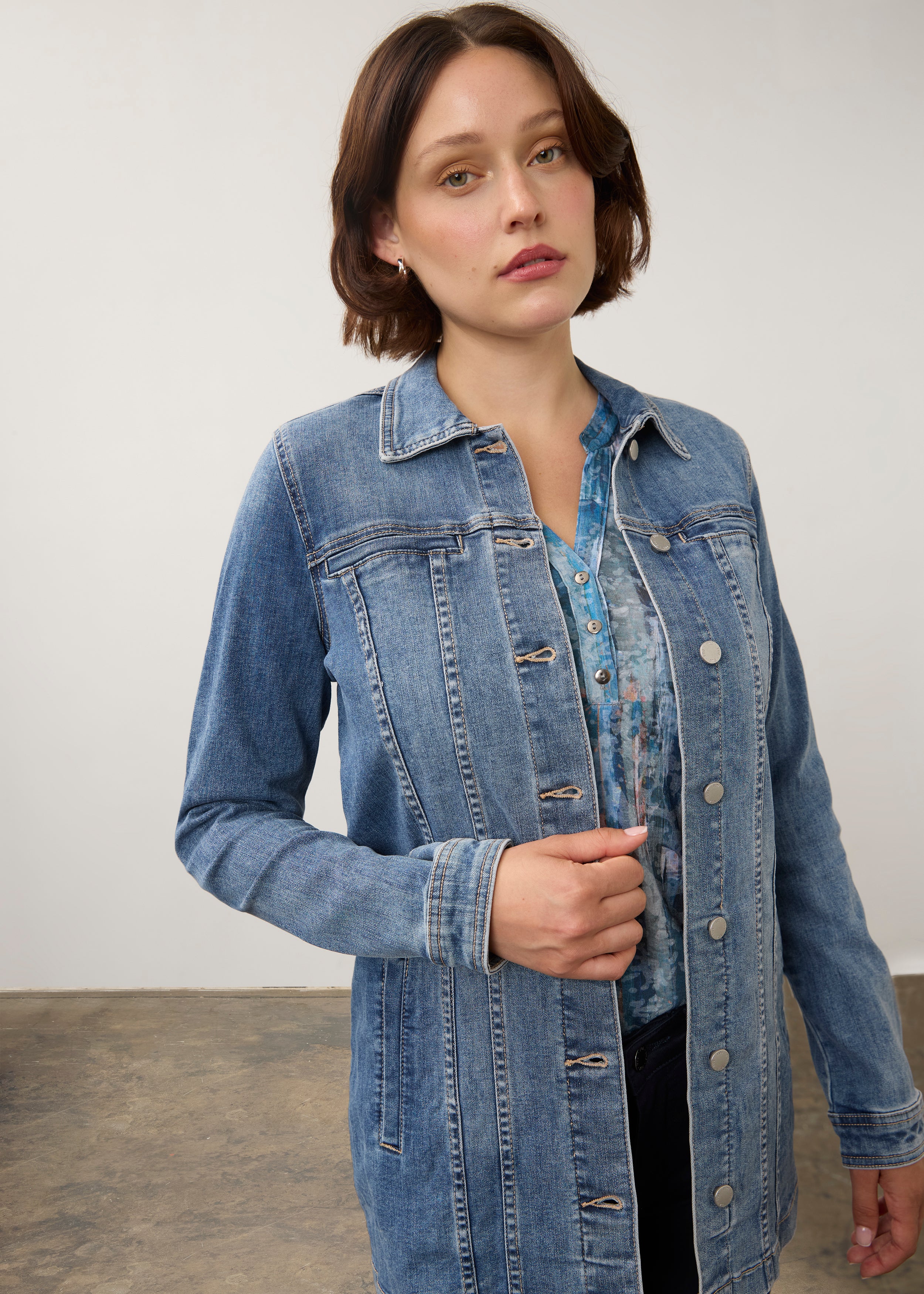Close-up front view of denim jacket in medium wash highlighting button details by French Dressing Jeans (FDJ) par French Dressing Jeans (FDJ)