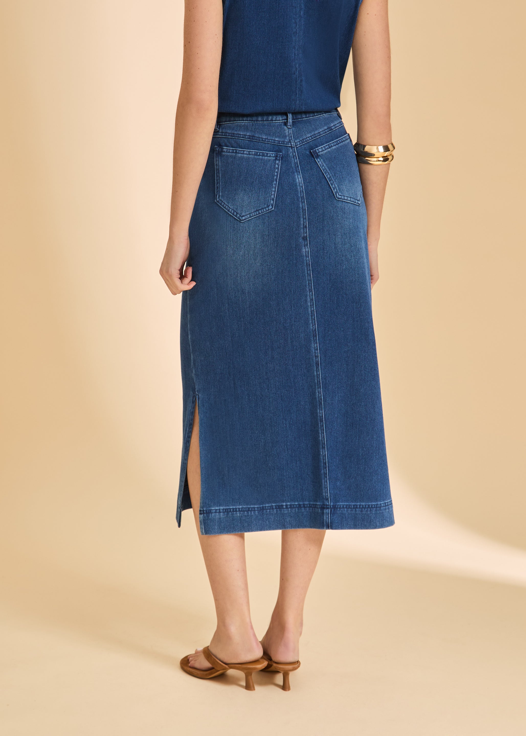 Back view of blue denim skirt featuring patch pockets and slit by French Dressing Jeans (FDJ)