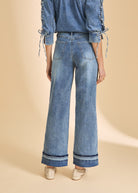 Back view of wide-leg denim with cuffed hem and patch pockets by French Dressing Jeans (FDJ)