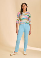 Front view of light blue straight-leg jeans, paired with colorful top by French Dressing Jeans (FDJ)