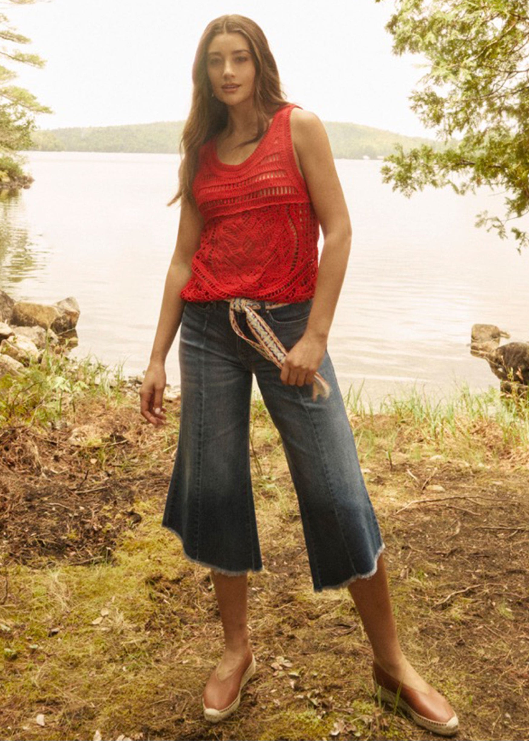 Woman in red crochet tank top by a lakeside setting by French Dressing Jeans (FDJ)