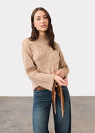 Full view of light camel sweater highlighting abstract embroidery with jeans by French Dressing Jeans (FDJ)