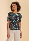 Front view of black floral short sleeve top with smocked sleeves and round neckline by French Dressing Jeans (FDJ)