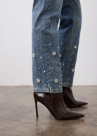 Close-up of indigo jeans fabric showing pearl embellishments on leg by French Dressing Jeans (FDJ)