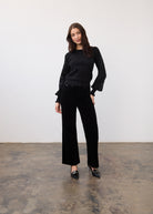 Full outfit view with black sweater and velvet sleeves, styled with black pants by French Dressing Jeans (FDJ)