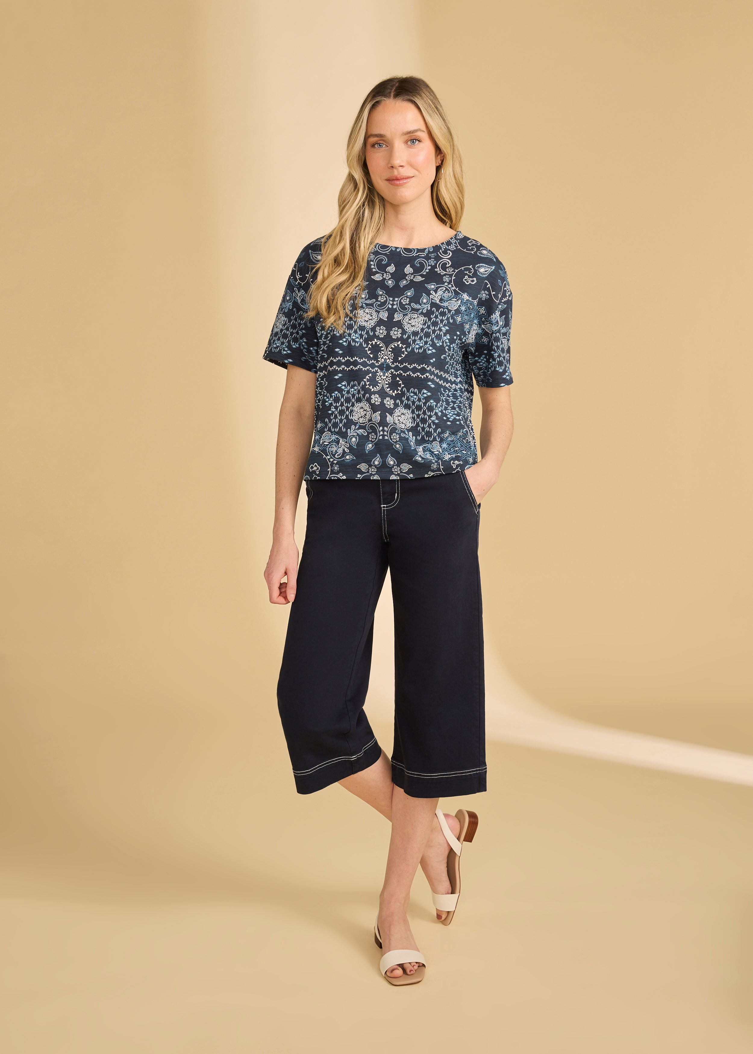 Full body view of blue Polynesian block print top paired with black pants and sandals by French Dressing Jeans (FDJ)