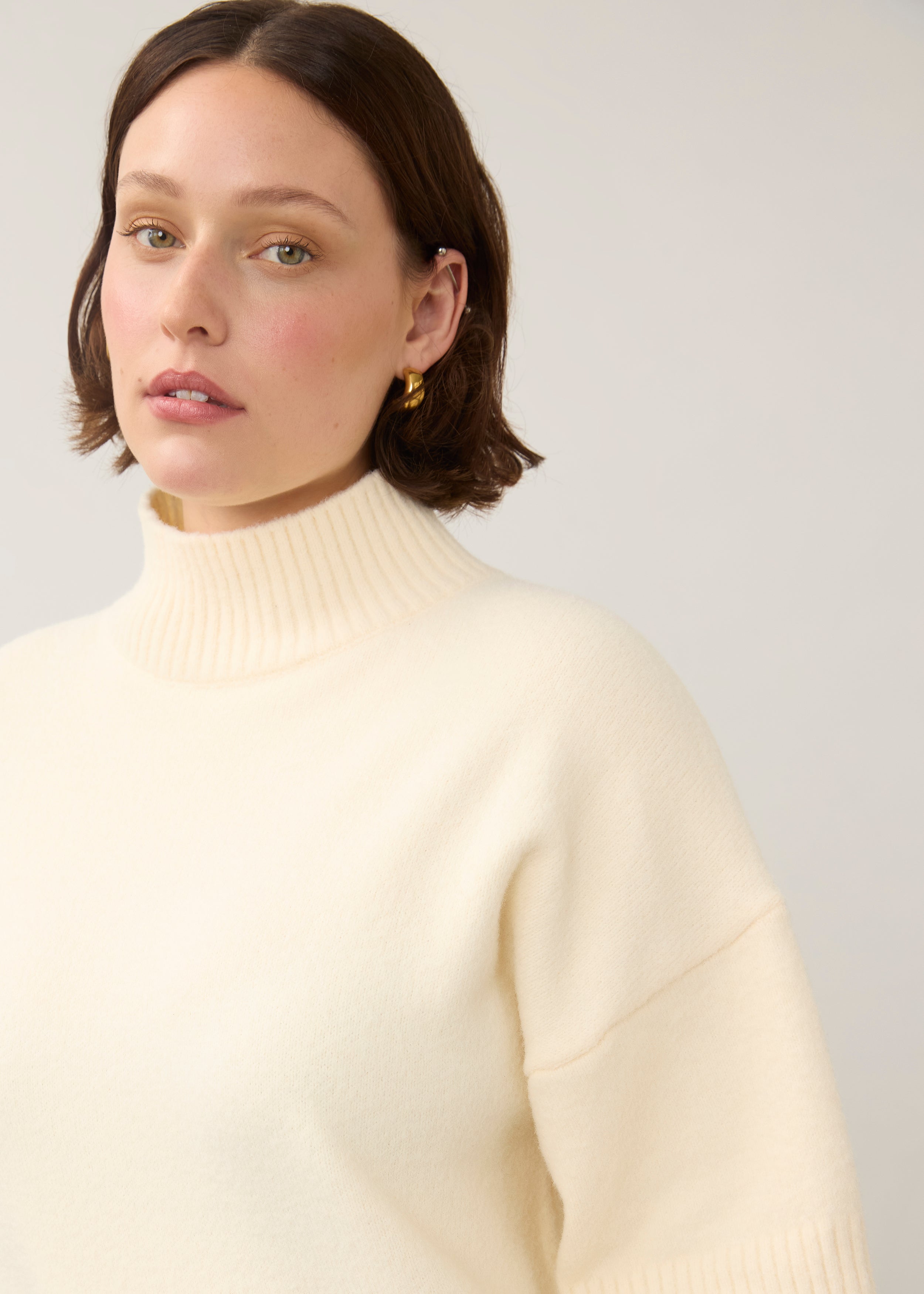 Close-up of cream tunic sweater focusing on ribbed high collar by French Dressing Jeans (FDJ)