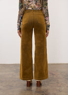 Back view of brass Olivia wide leg pants highlighting patch pockets by French Dressing Jeans (FDJ)