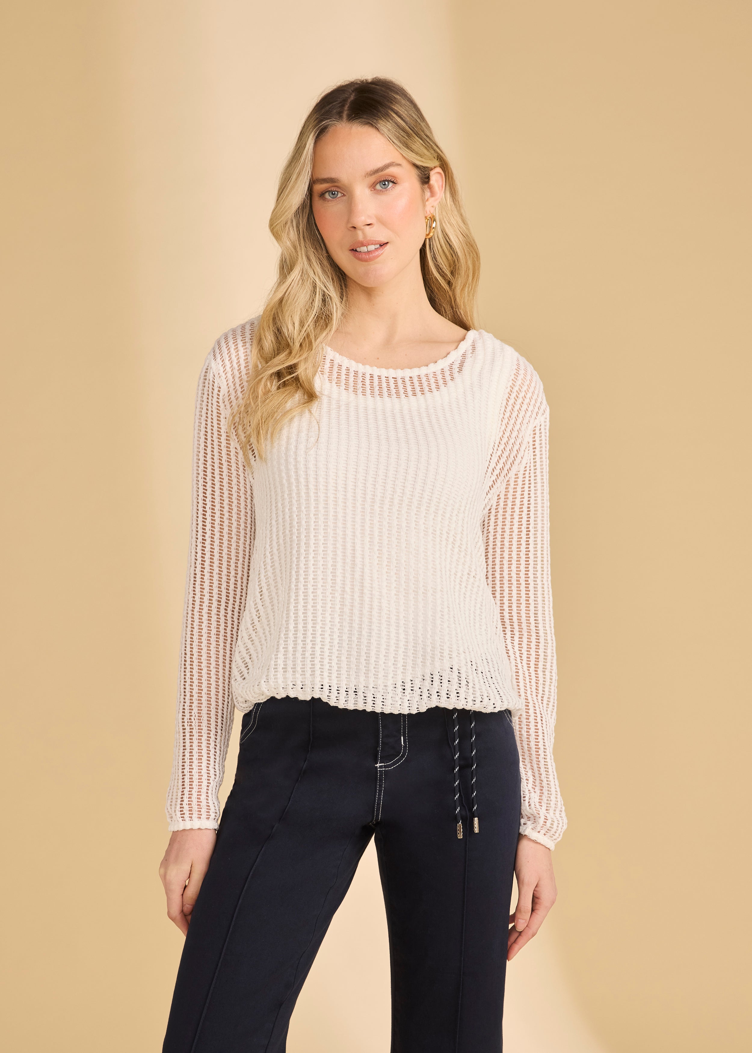 Front view of white mesh long sleeve top with scoop neck paired with navy pants by French Dressing Jeans (FDJ)