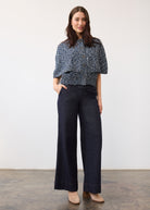 Full view of a textured blue knit top paired with wide-leg dark wash denim highlighting overall fit by French Dressing Jeans (FDJ)