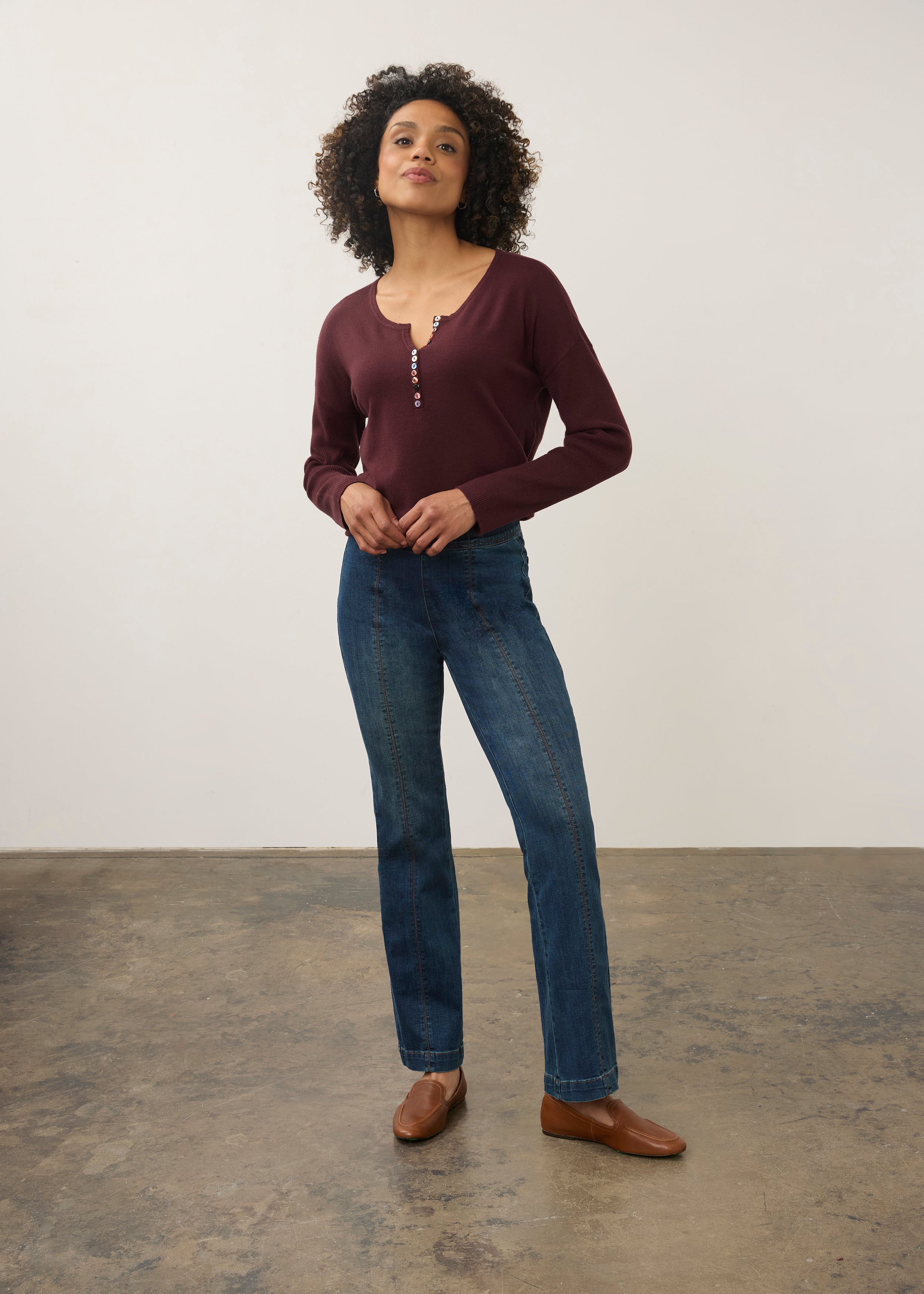 Model in medium blue jeans with maroon top, front view showing fitted waist by French Dressing Jeans (FDJ) par French Dressing Jeans (FDJ)