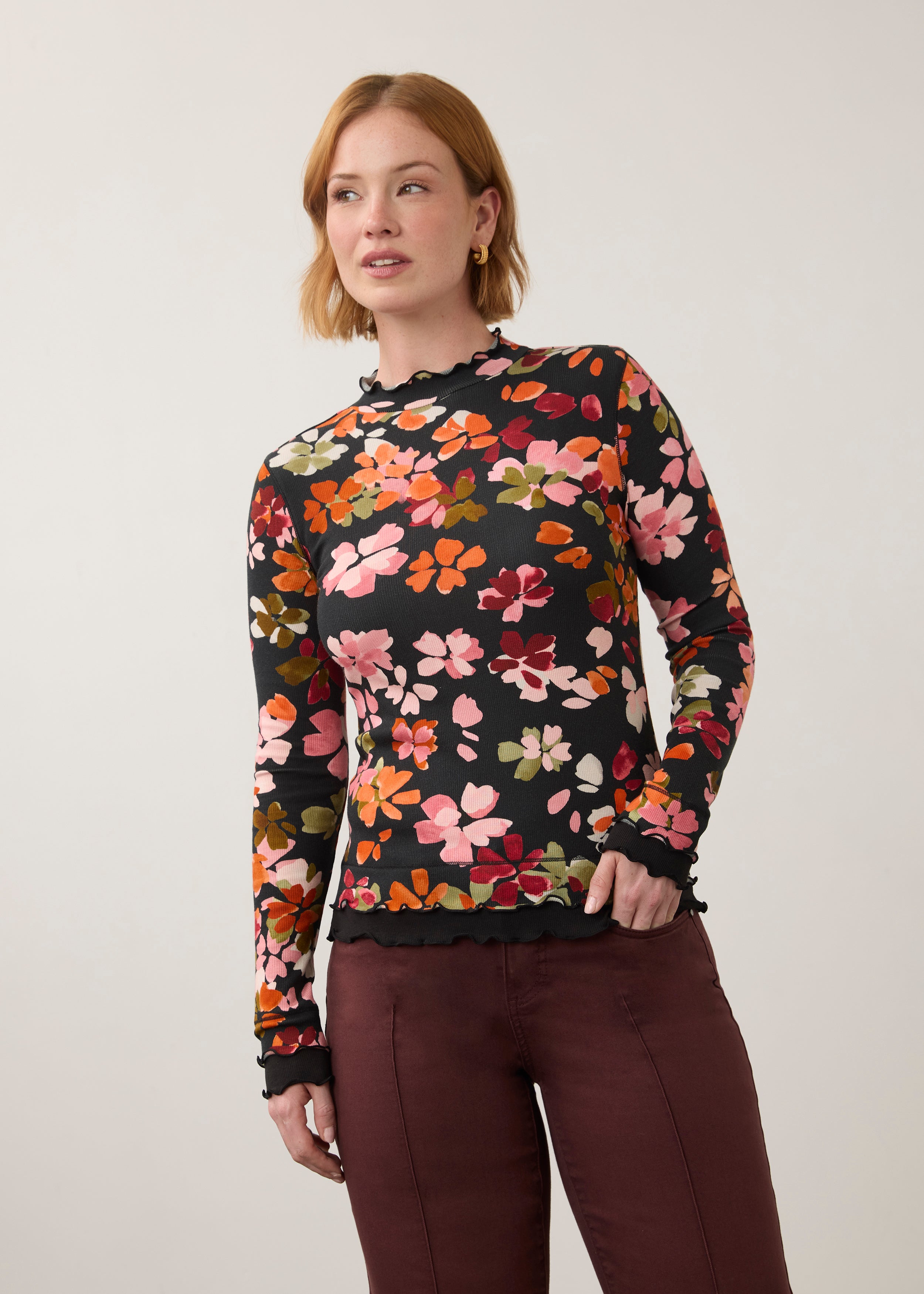 Front view of vibrant floral top with ruffled edges, paired with maroon pants by French Dressing Jeans (FDJ)