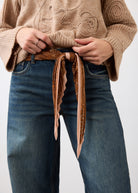 Close-up of front patch pockets and belt detail on medium blue jeans by French Dressing Jeans (FDJ)