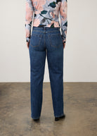 Back view of dark wash jeans with floral top, showcasing back patch pockets by French Dressing Jeans (FDJ) par French Dressing Jeans (FDJ)