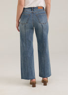Back view of Olivia wide ankle jeans in light wash featuring back pockets and mid-rise design by French Dressing Jeans (FDJ)