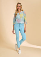 Full view of pastel patterned top paired with blue pants by French Dressing Jeans (FDJ)
