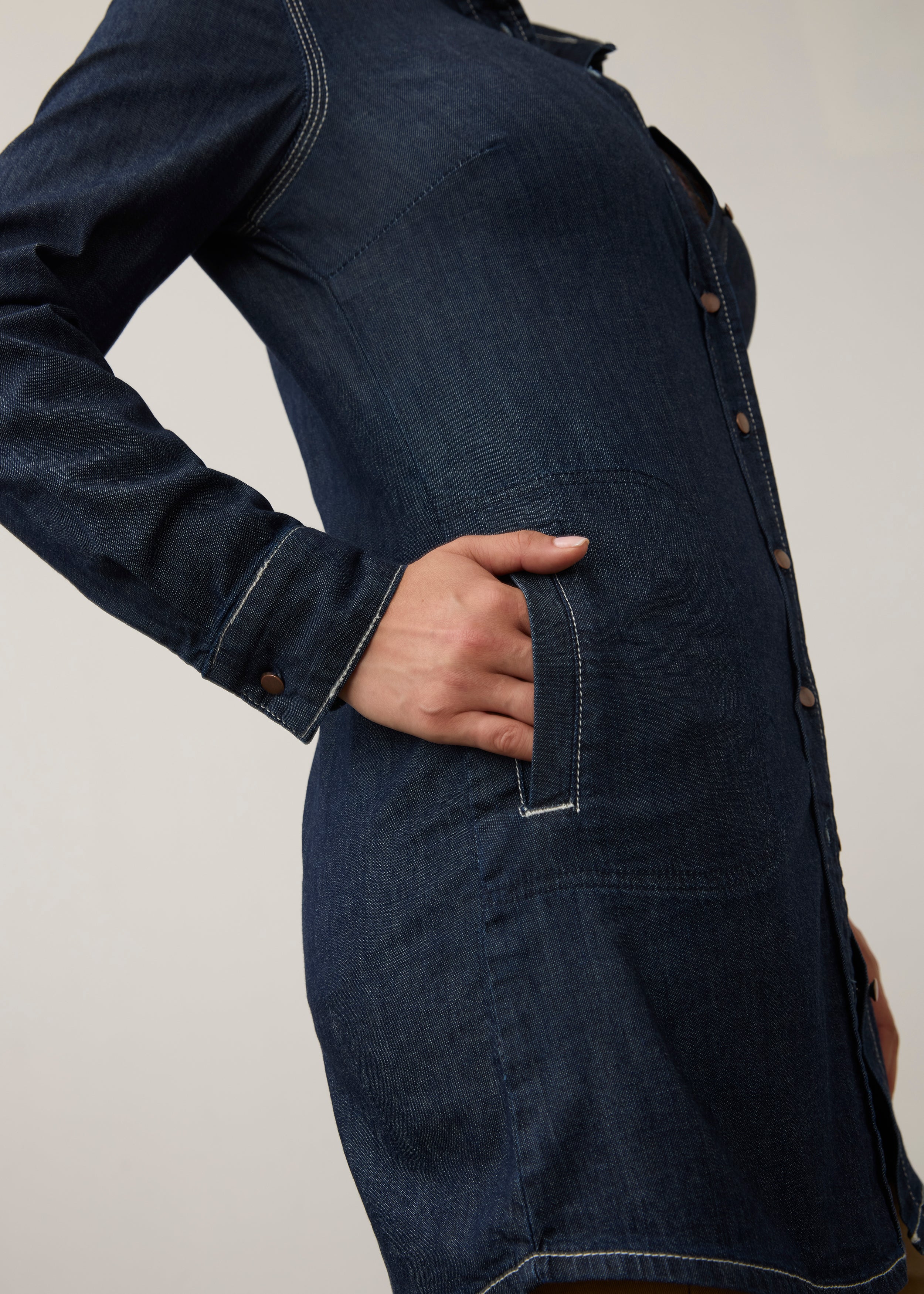 Side detail of dark wash tunic highlighting side patch pocket and buttoned cuff by French Dressing Jeans (FDJ)