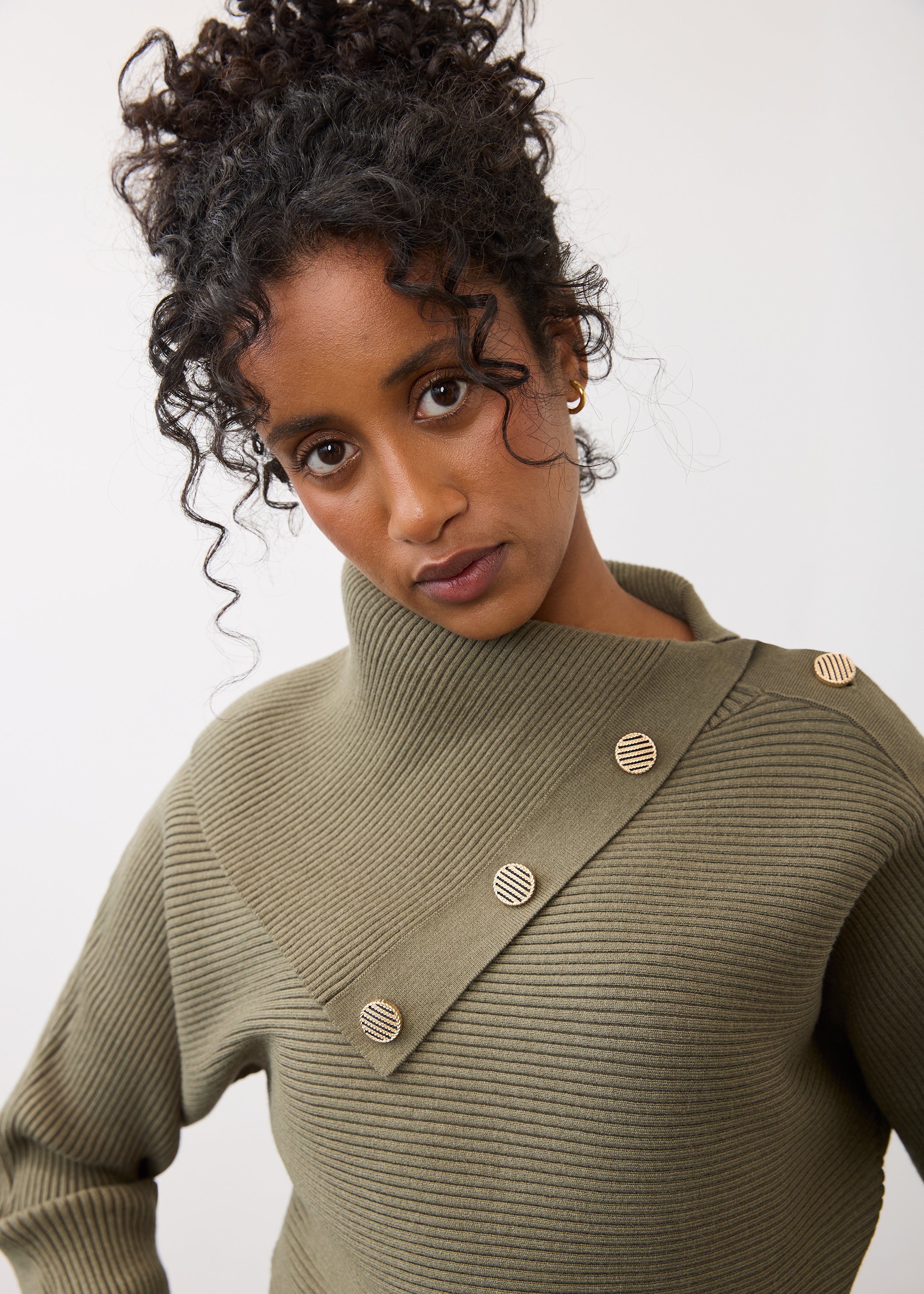 Close-up of olive sweater showcasing button detail on shoulder by French Dressing Jeans (FDJ)