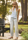 Outdoor view of light wash sleeveless denim top and jeans ensemble by French Dressing Jeans (FDJ)