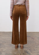 Back view of camel wide leg pants highlighting structured design and patch pockets by French Dressing Jeans (FDJ)