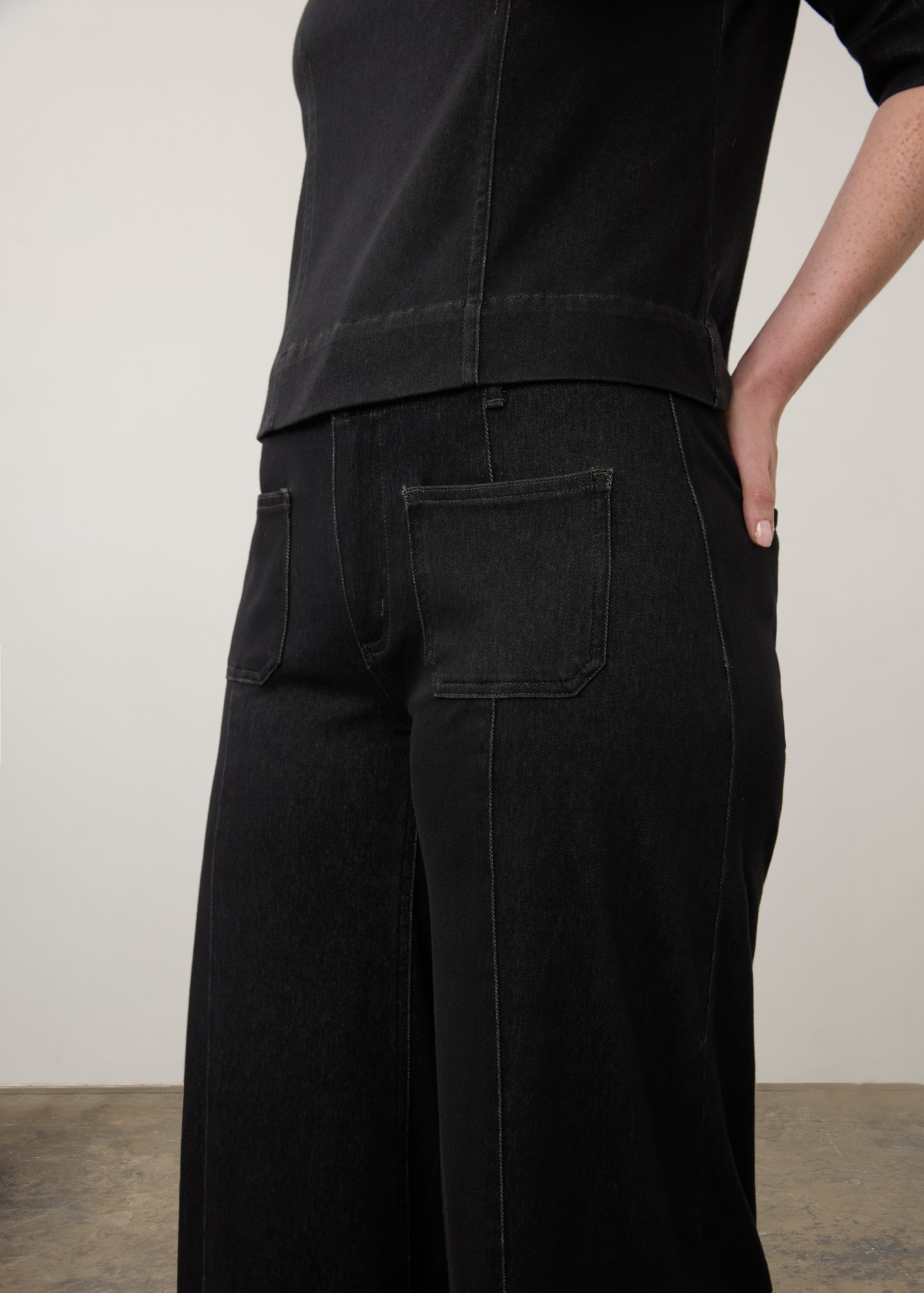 Side detail of black wide-leg jeans focusing on pocket design and stitching by French Dressing Jeans (FDJ)