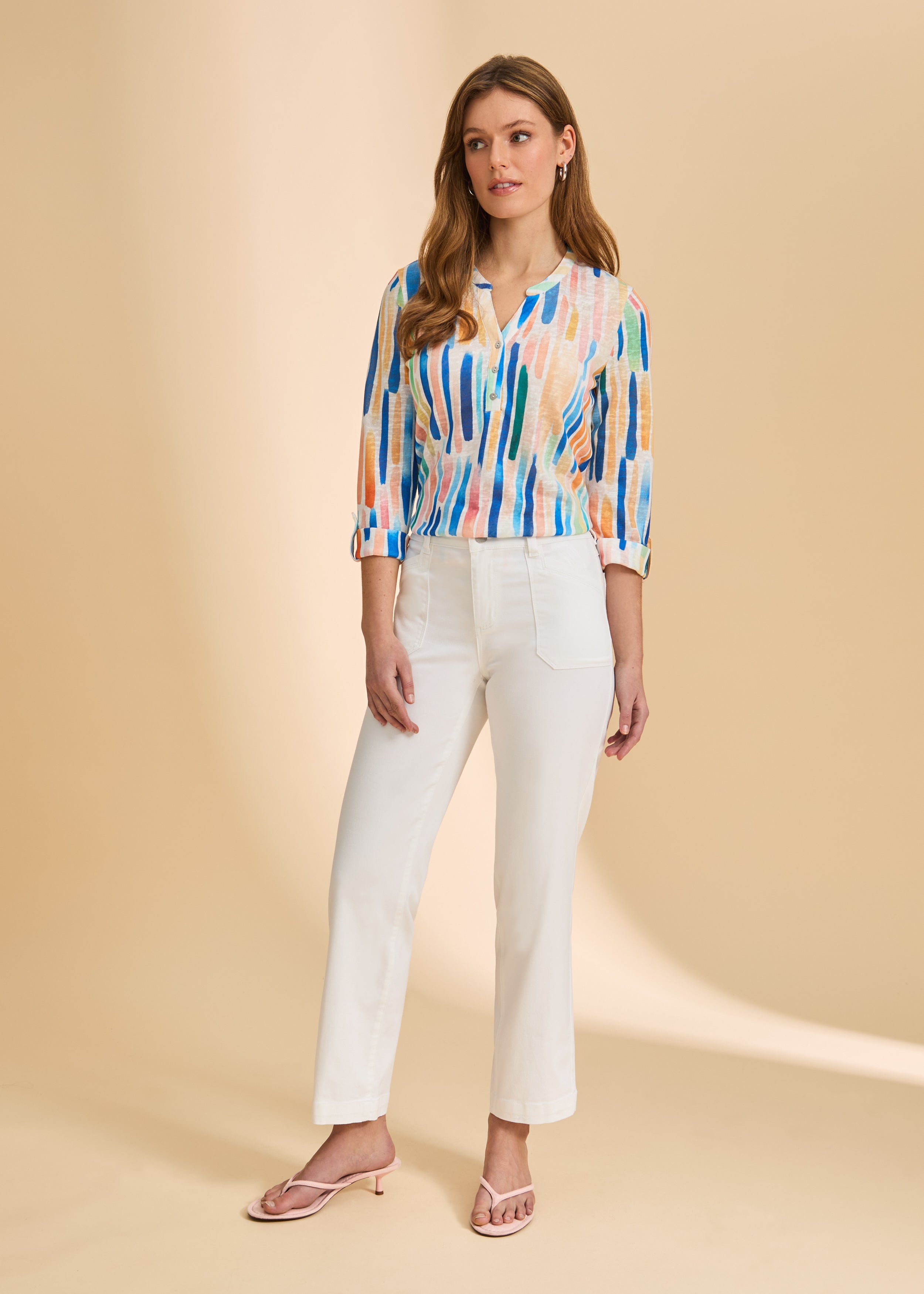 Full body view of bright Henley top paired with white pants, highlighting casual style by French Dressing Jeans (FDJ)